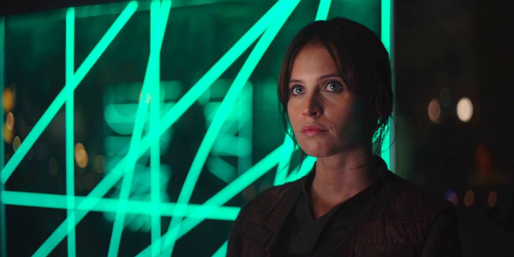 Jyn Erso stands next to a grid of green lights in Star Wars Rogue One