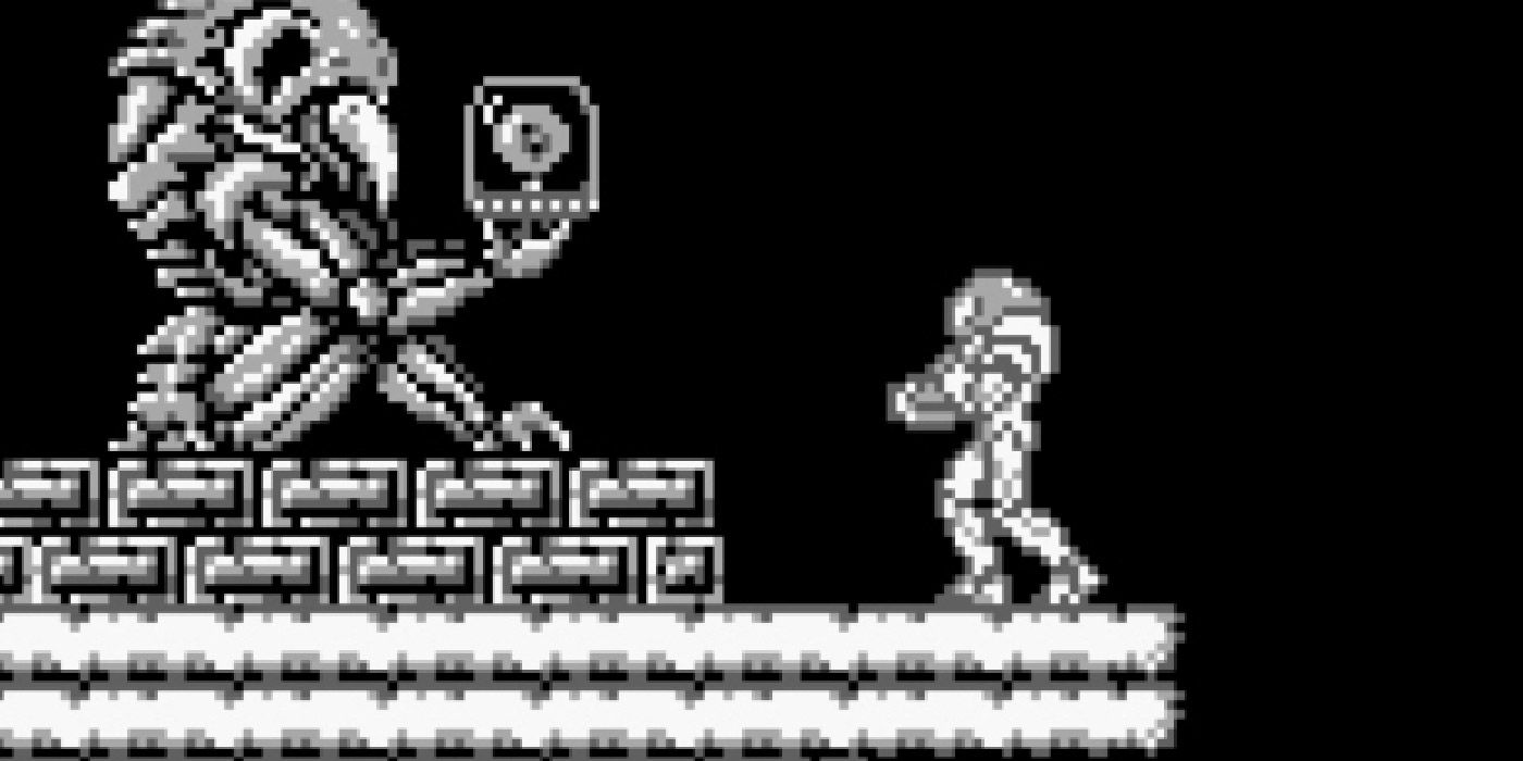 Samus prepares to take a weapon upgrade from a Chozo statue in Metroid II: The Return of Samus