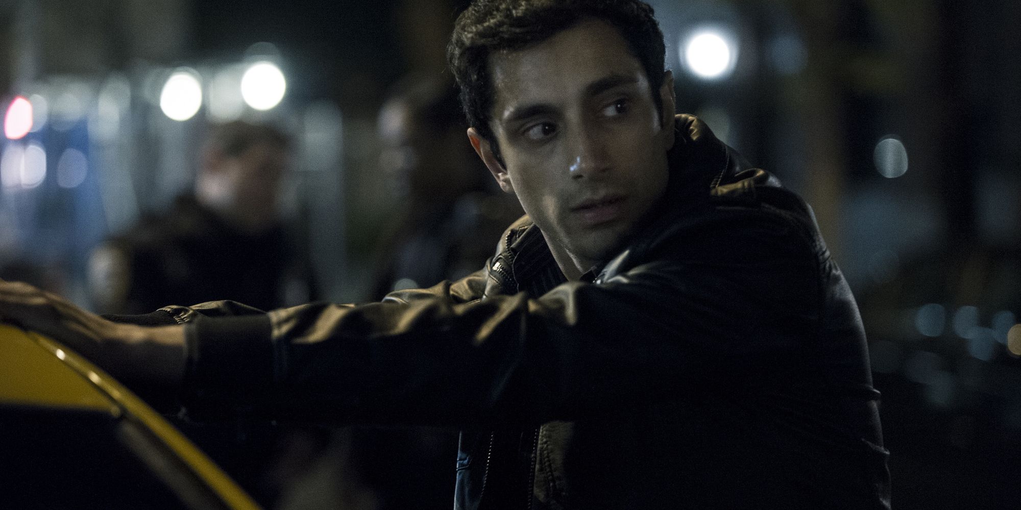 Riz Ahmed's character with his hands on the top of a car in The Night Of