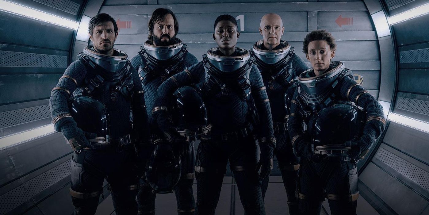 The Characters in Nightflyers with space gear on looking serious.