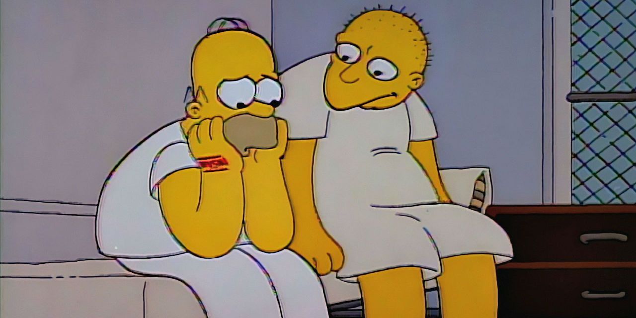 Homer looking sad while a man sits beside him in The Simpsons.