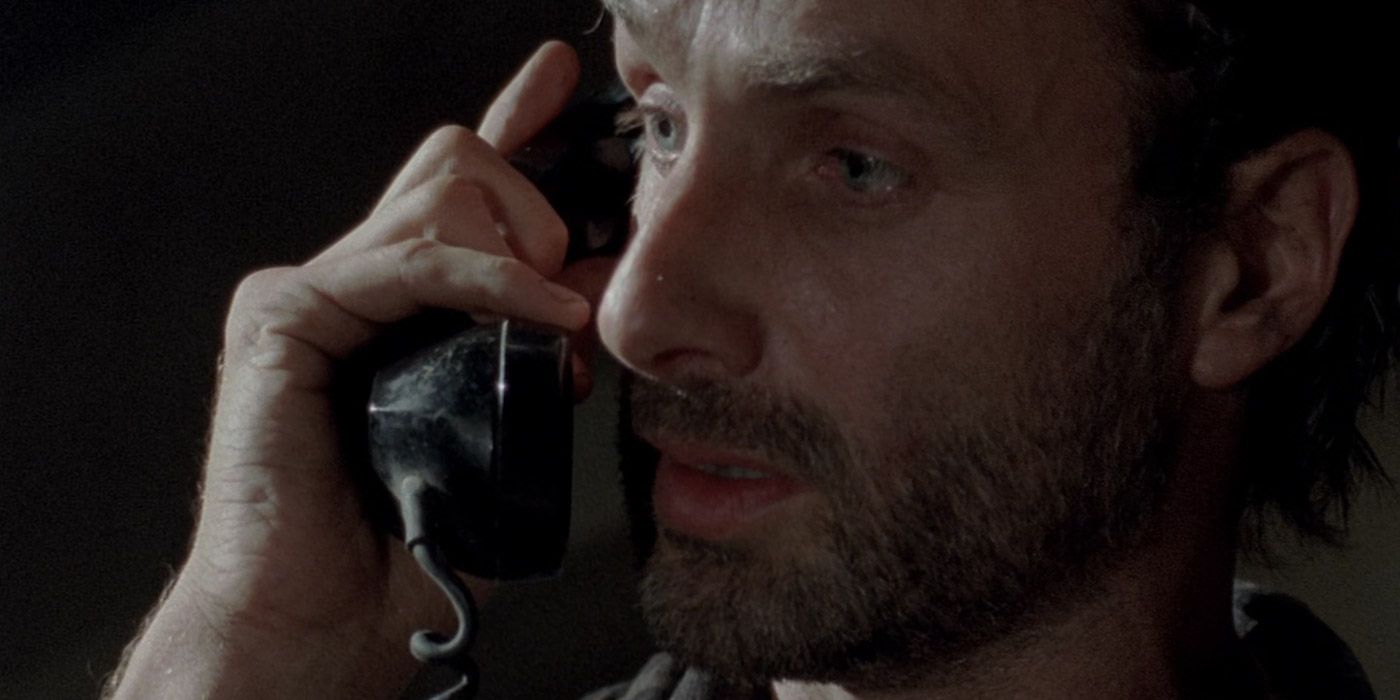 Rick takes a call in The Walking Dead