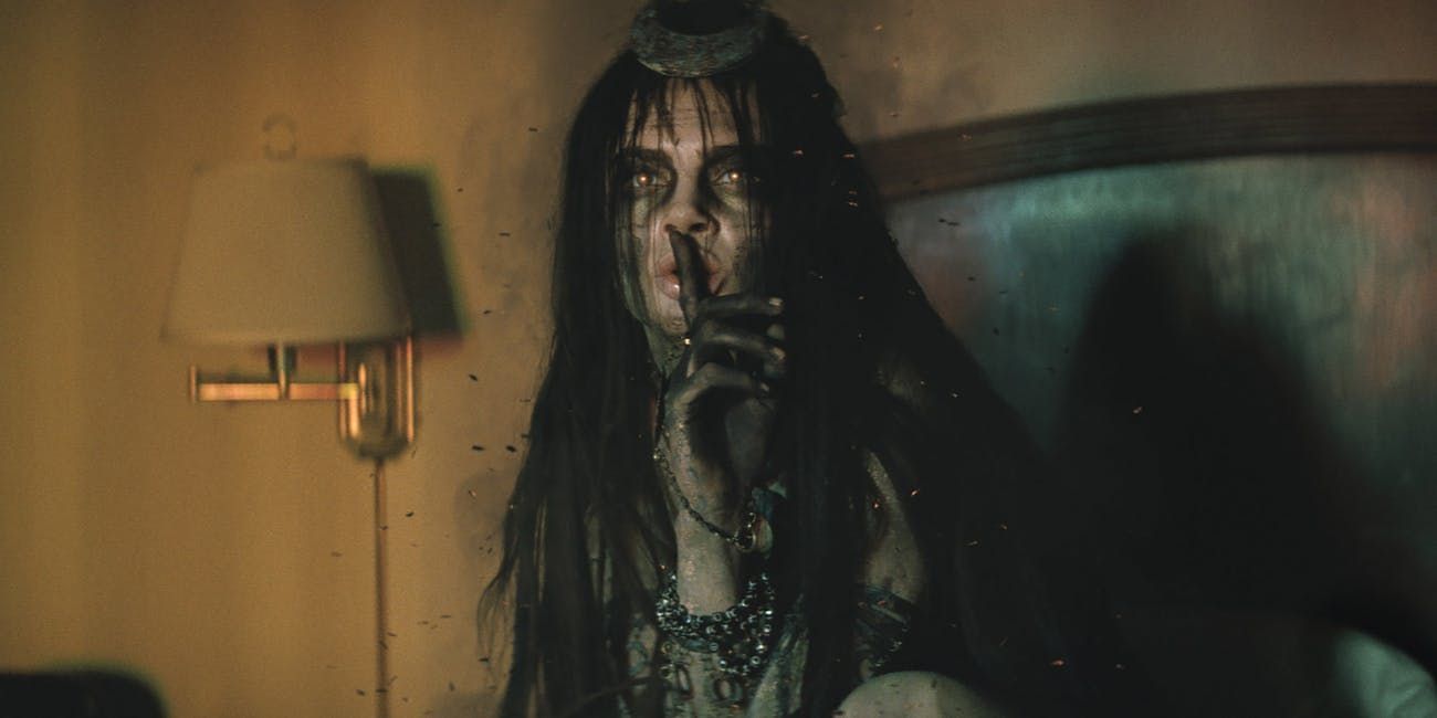 Enchantress doing a shushing gesture in Suicide Squad (2016)