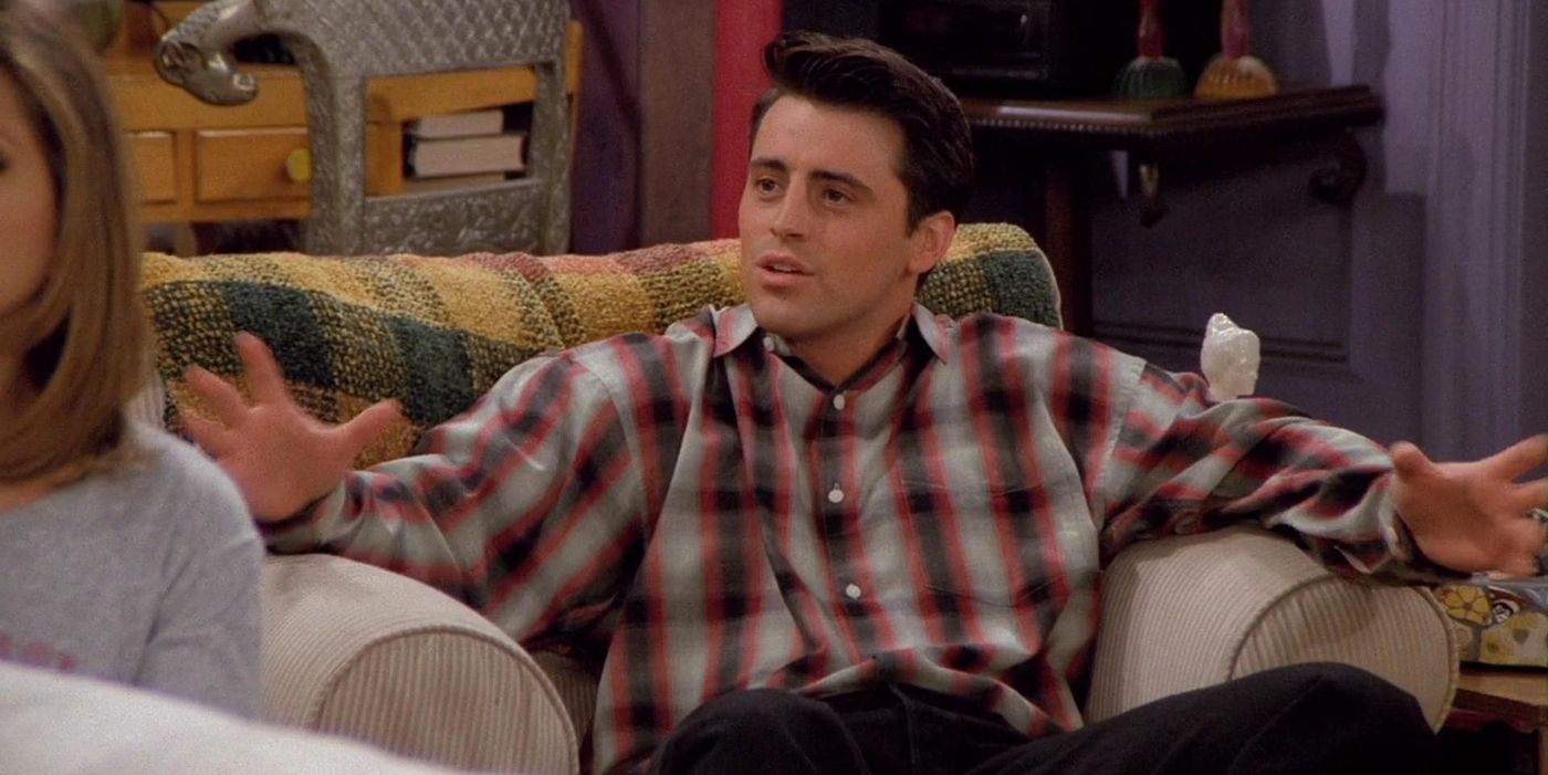 Joey sitting in a chair in Friends, talking.