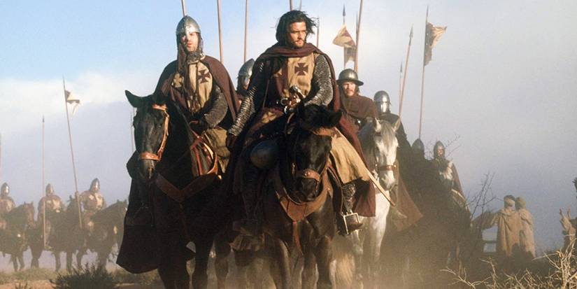 Orlando Bloom riding a horse through a battlefield in Kingdom of Heaven