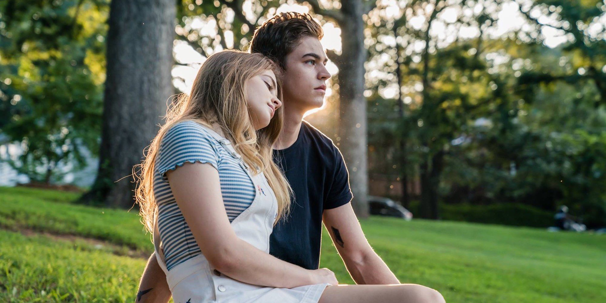 Tessa and Hardin sitting in a garden together in After