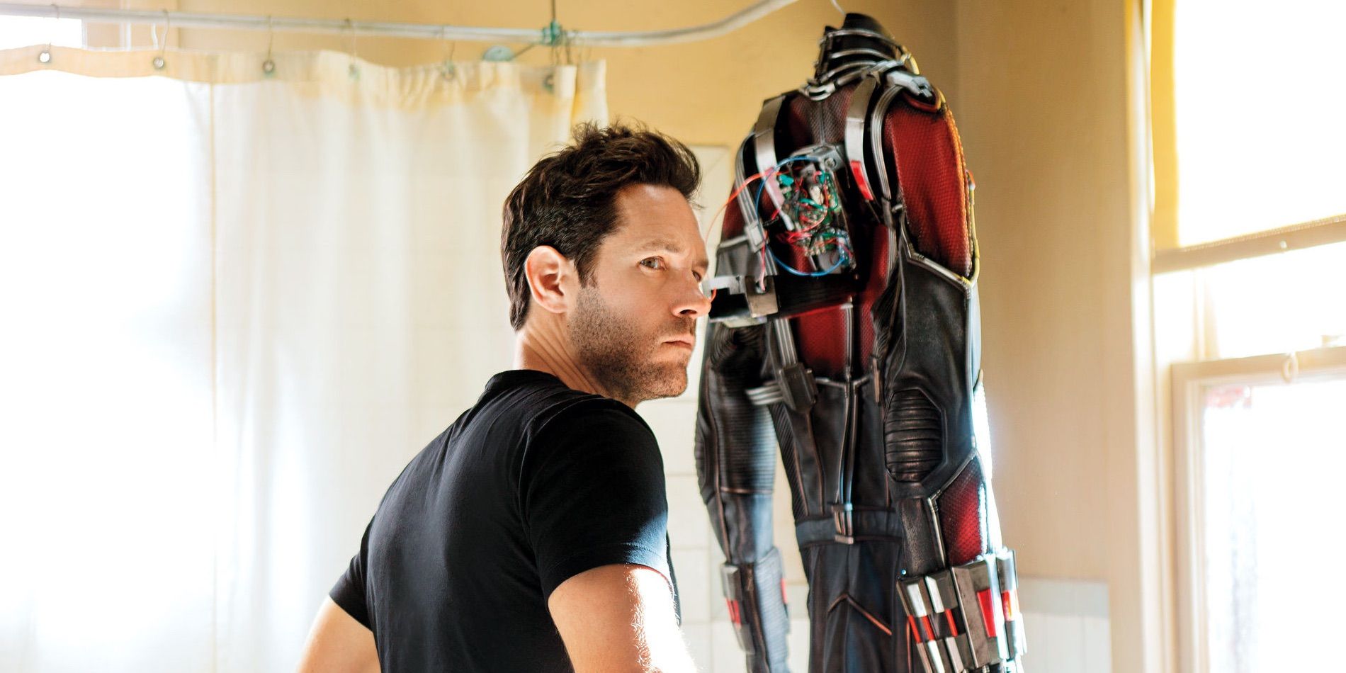 Scott Lang looking at suit hanging up in bathroom in Ant-Man