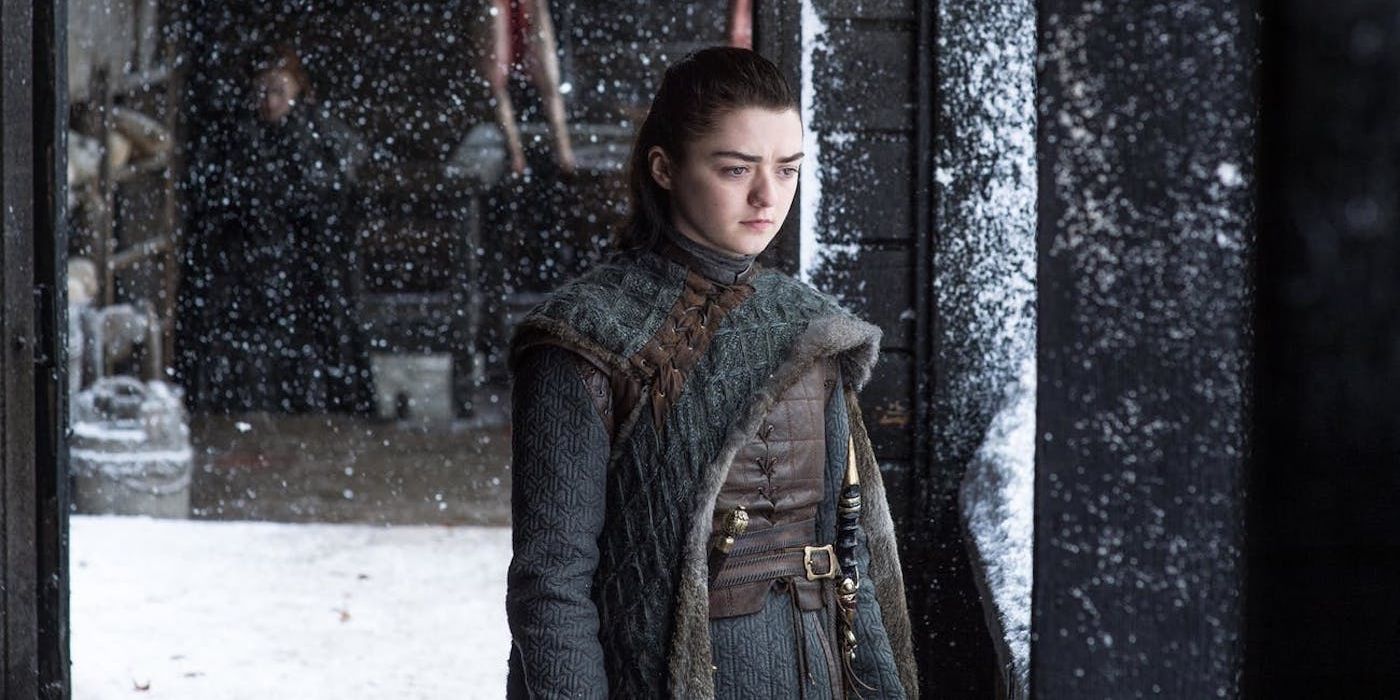 Arya Stark looking down at the Winterfell courtyard in Game of Thrones.