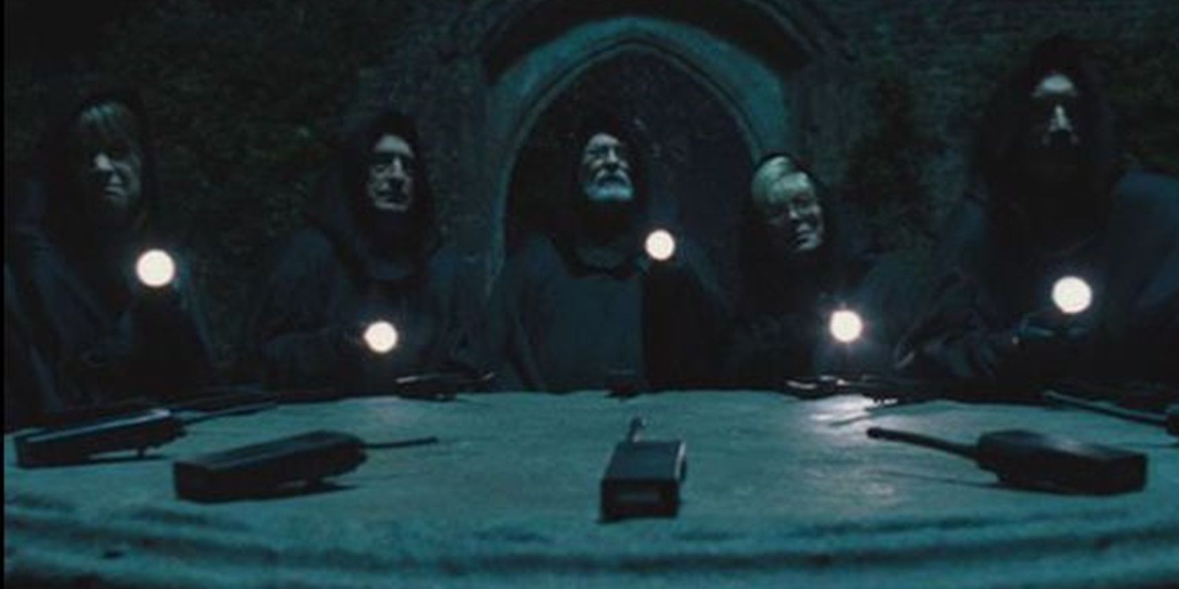 The neighbourhood watch in cloaks sitting around a table in Hot Fuzz