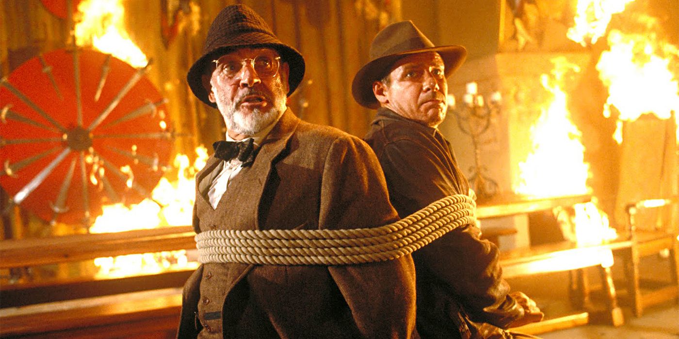 Indiana Jones and Dr. Henry Jones tied together surrounded by fire in The Last Crusade