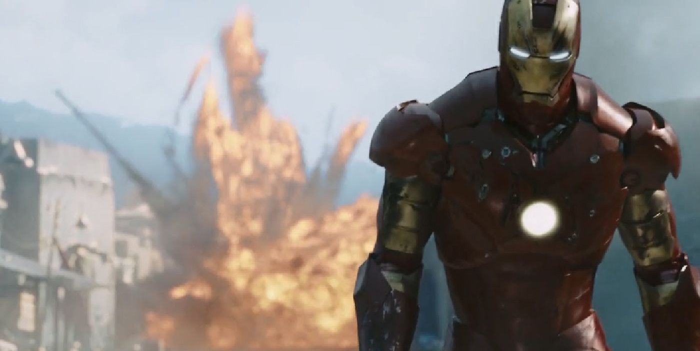Robert Downey Jr. as Iron Man walking away from an explosion in Iron Man (2008)