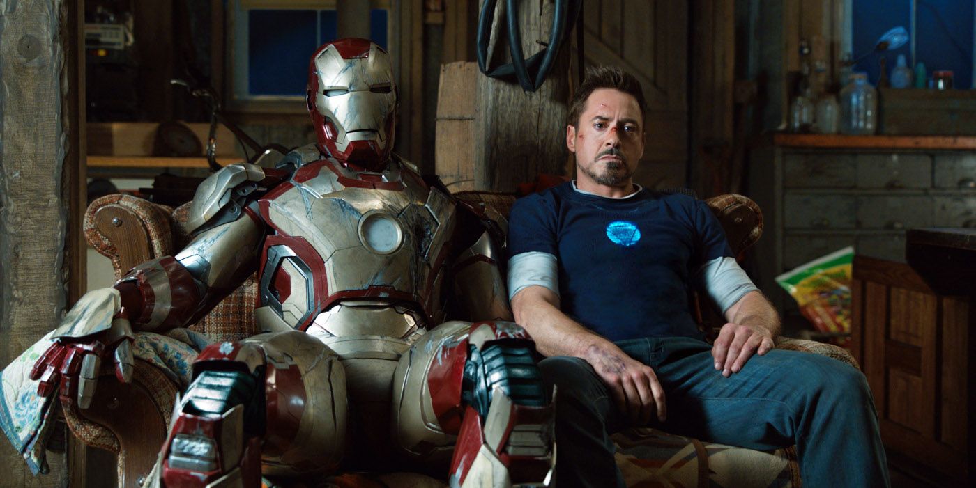 Tony Stark sits next to his armor in Iron Man 3