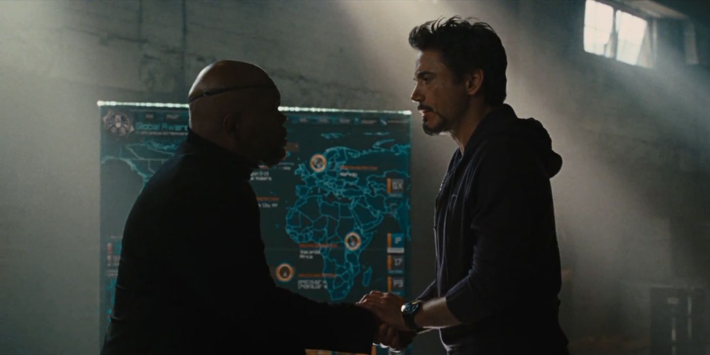 Nick Fury and Tony Stark meet in front of a map of the world