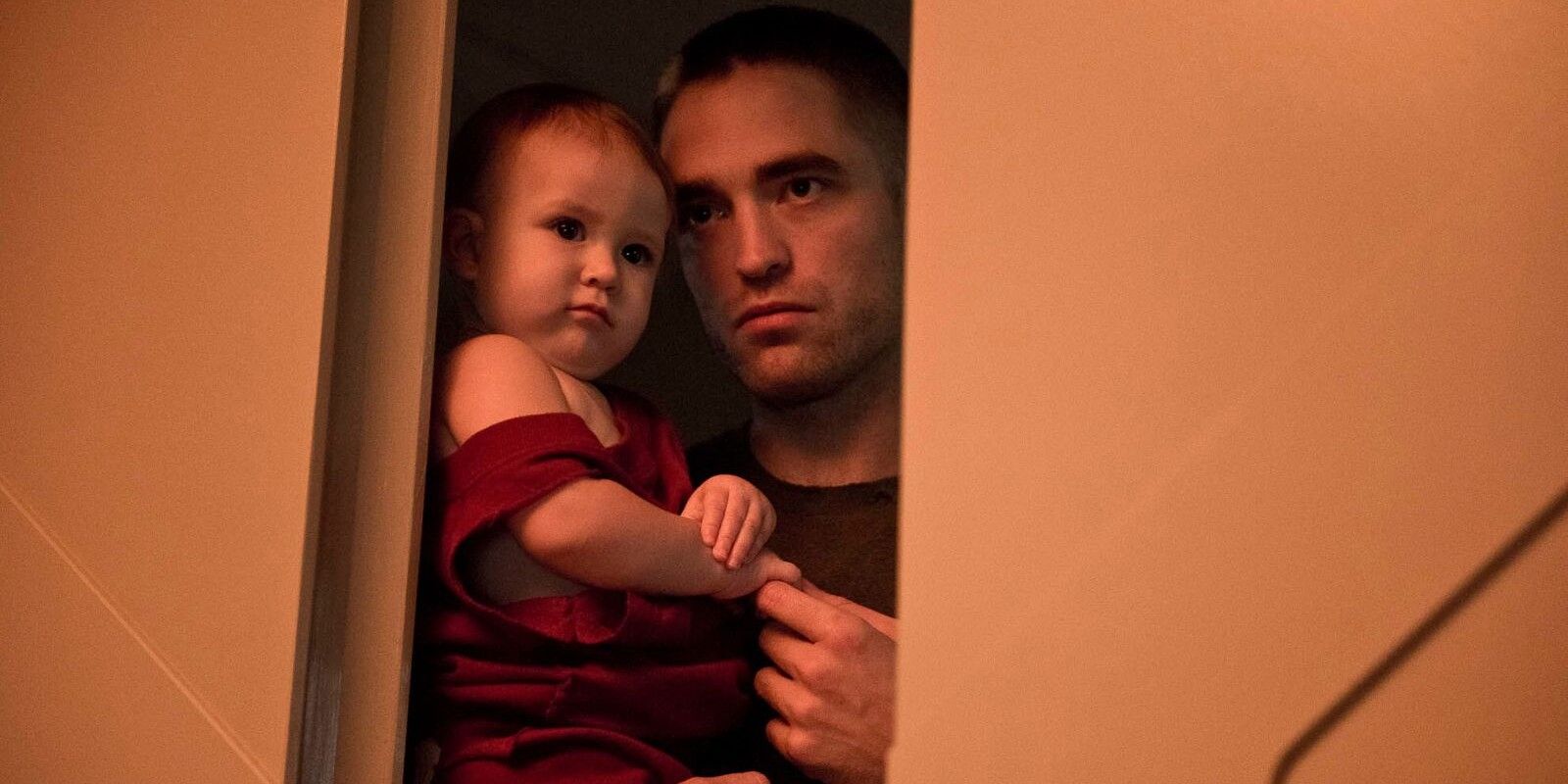 Robert Pattinson holding a baby in High Life