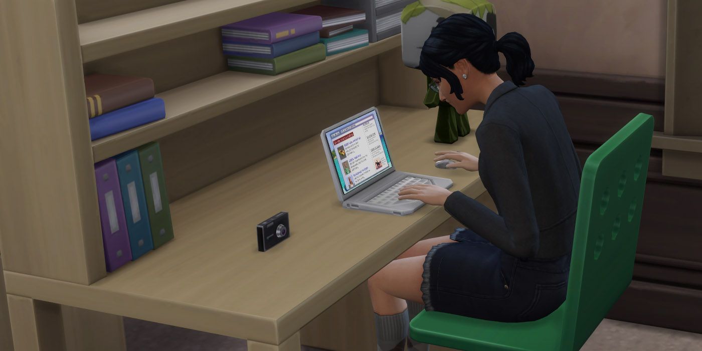 A female sim using a laptop in The Sims 4.