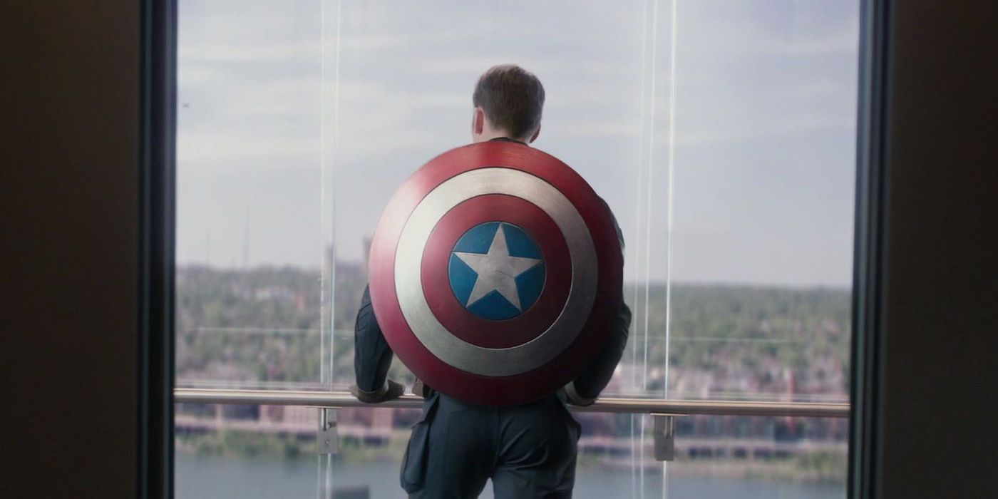 Steve Rogers wearing his shield on his back and looking out over Washington DC from the window of the Triskelion in Captain America The Winter Soldier