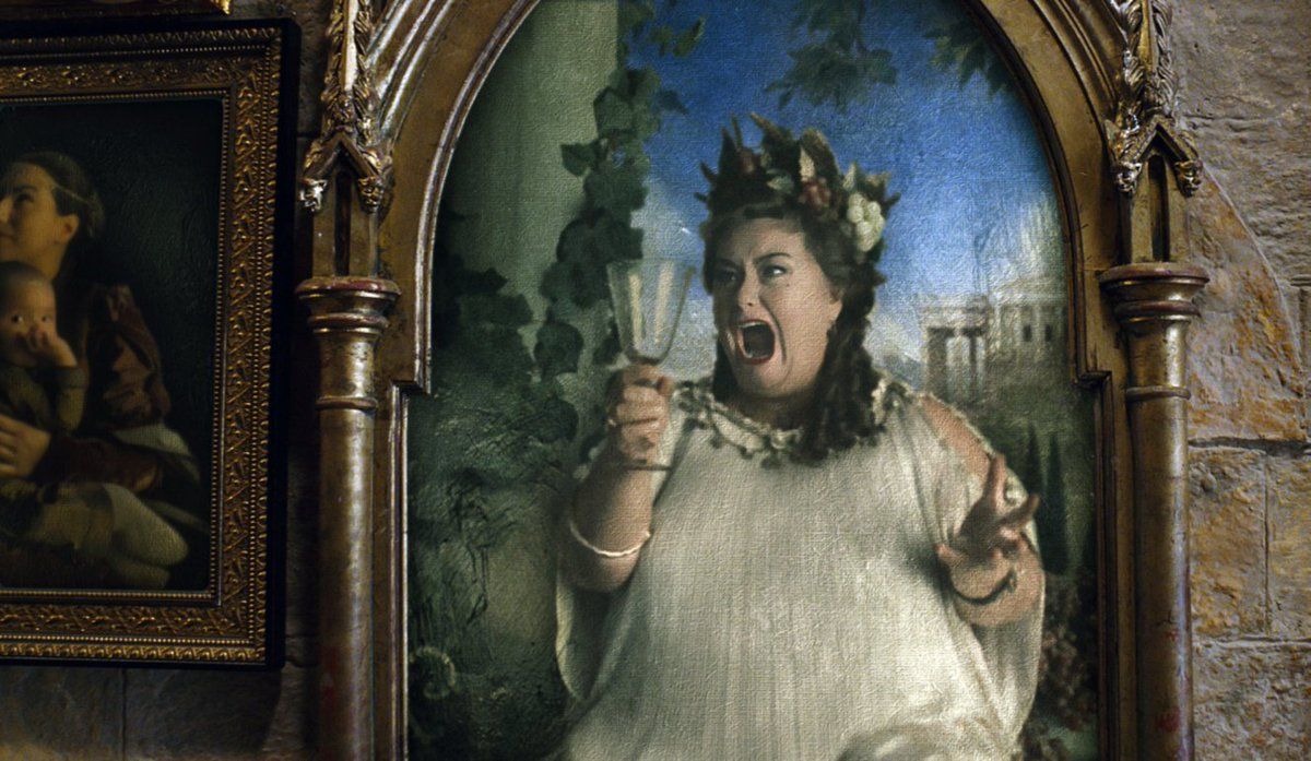 Dawn French in a painting in Harry Potter holding a wine glass and singing.