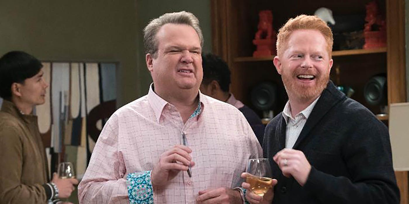 Mitch and Cam smile at a house party on Modern Family