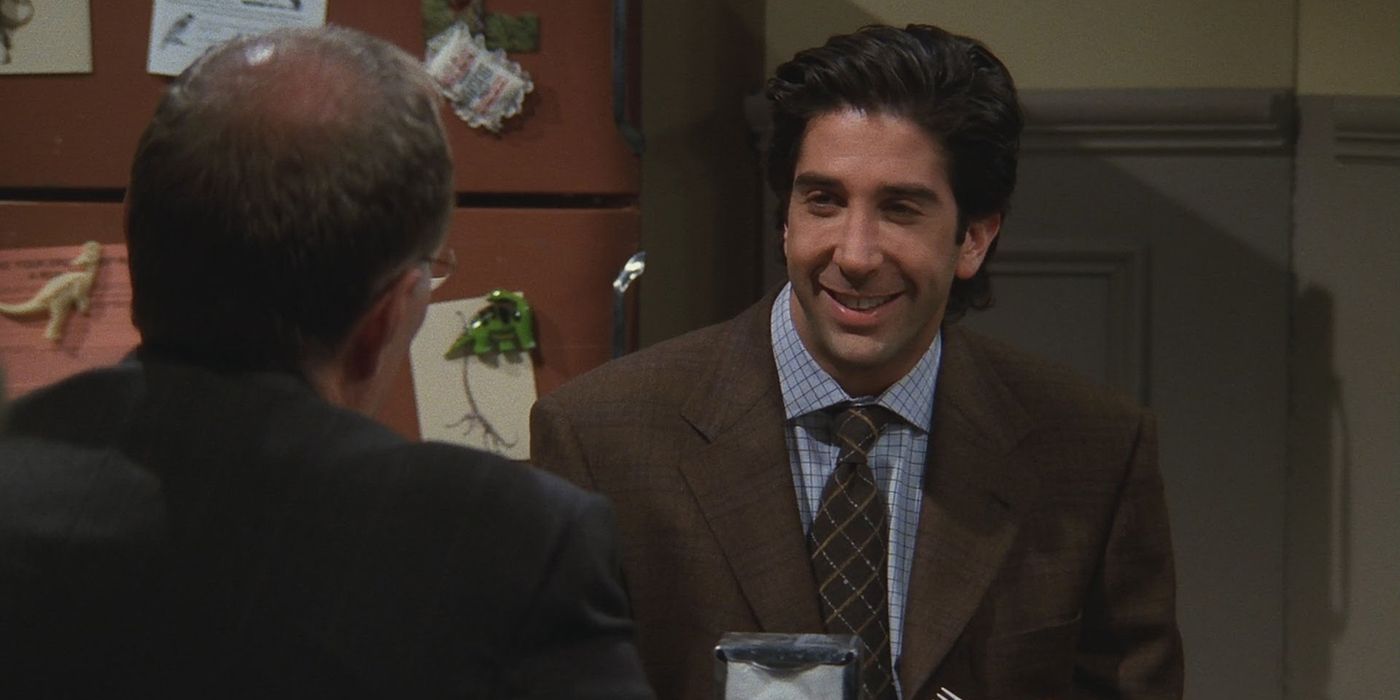 Ross at work smiling to his boss in Friends
