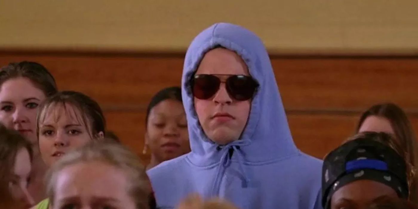 Damien hides in a hoodie and sunglasses in the gym in Mean Girls