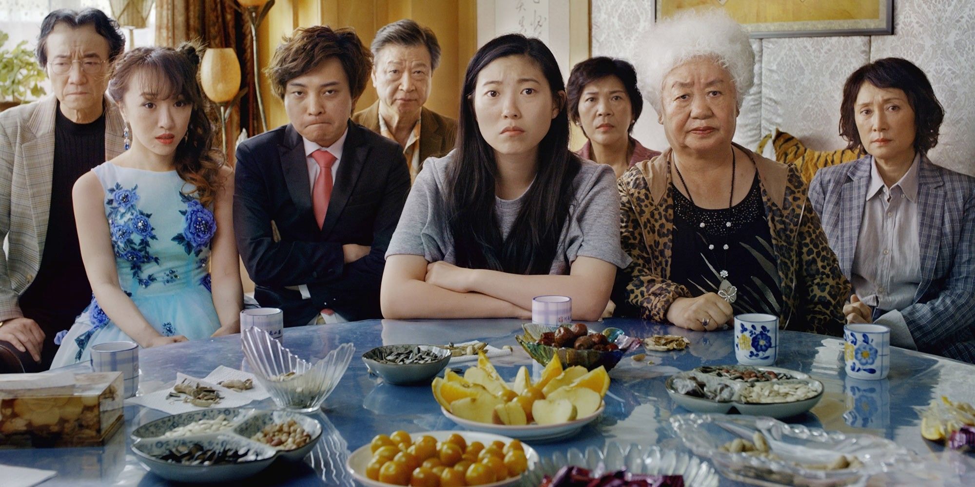 Awkwafina and The Farewell cast look at the camera.