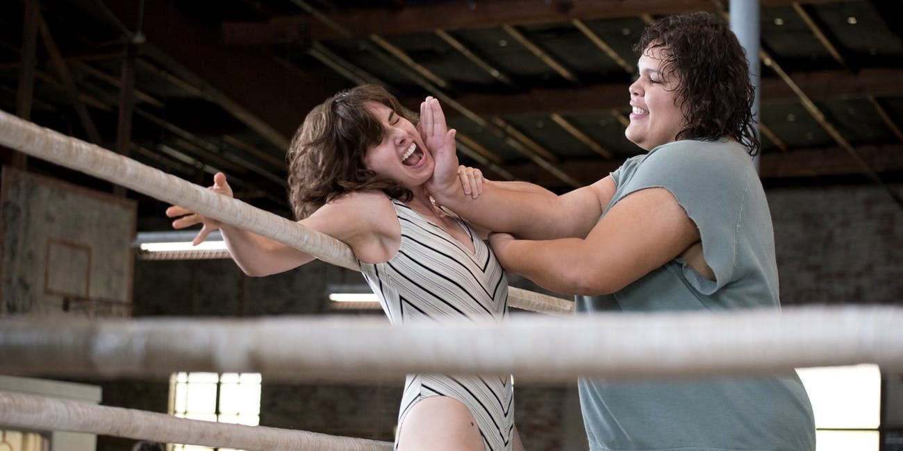 Carmen from GLOW pushing a girl's head against the ring