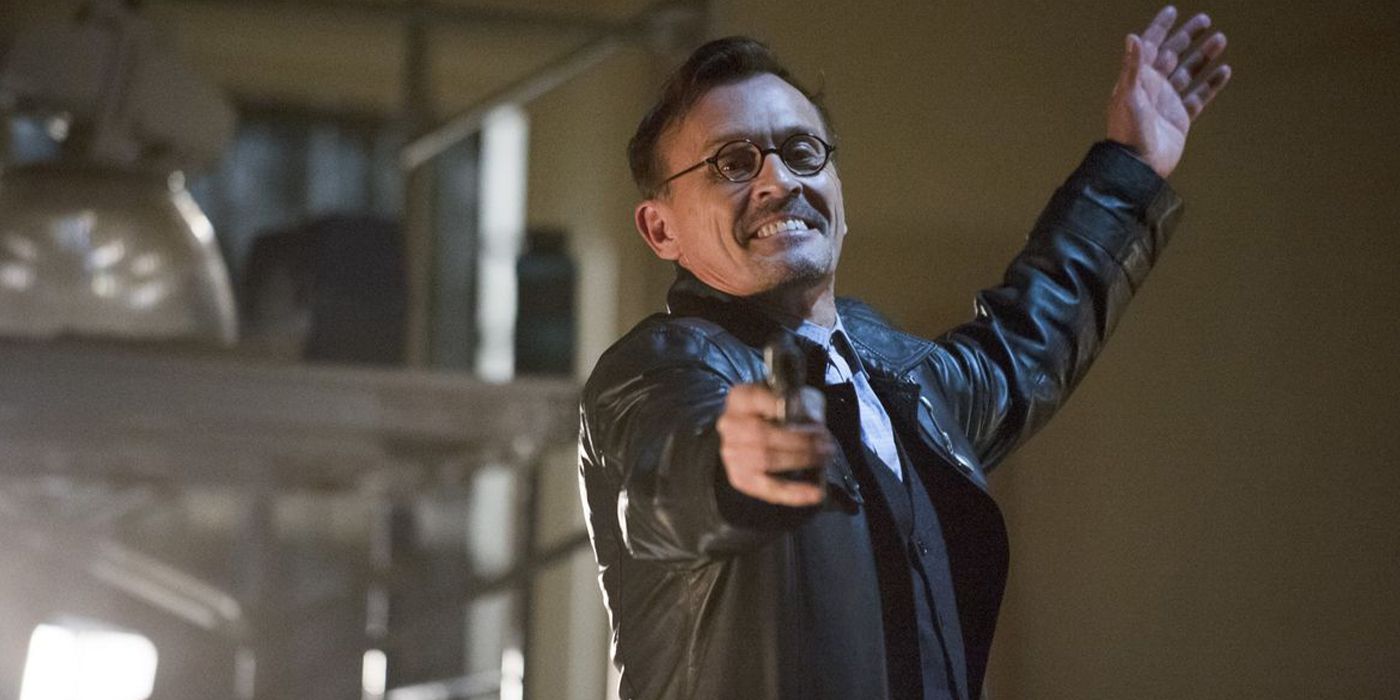 The Clock King pointing a gun in Arrow