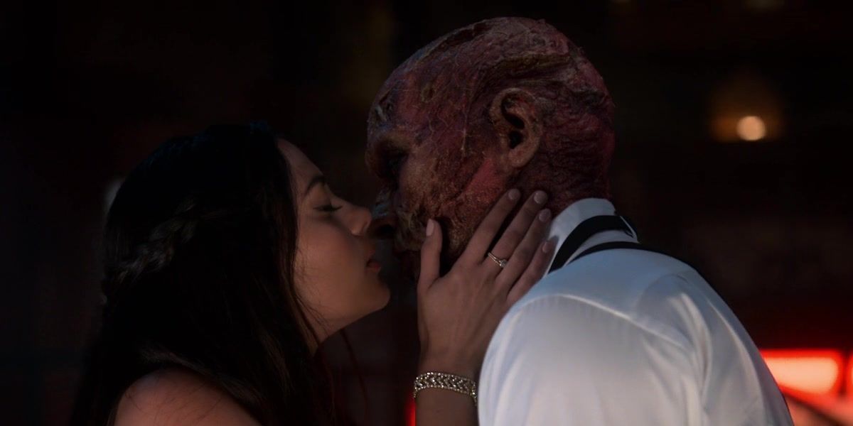 Eve and Lucifer kissing while Lucifer is wearing his devil face.