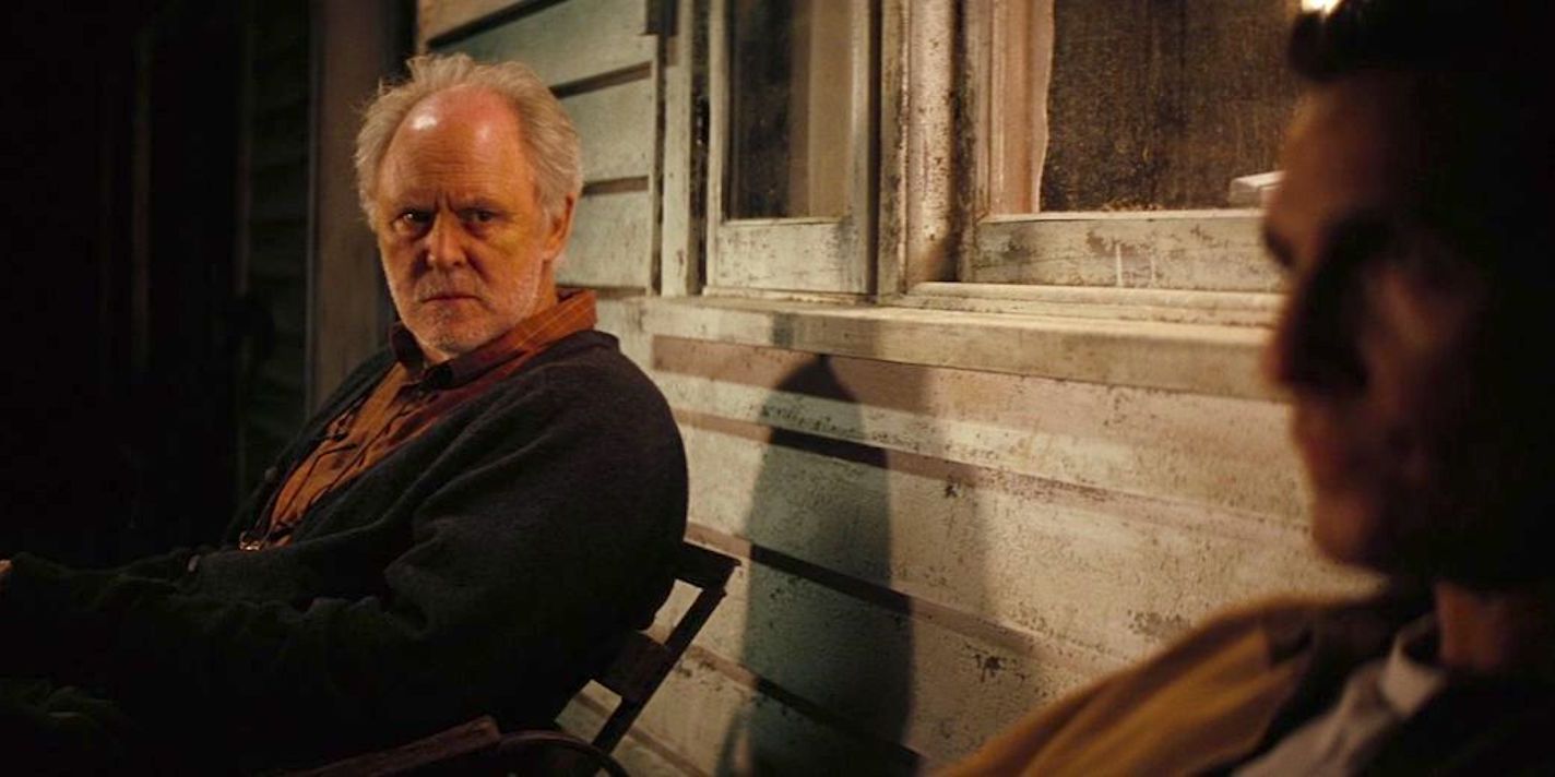 John Lithgow as Donald sitting on the porch in Interstellar