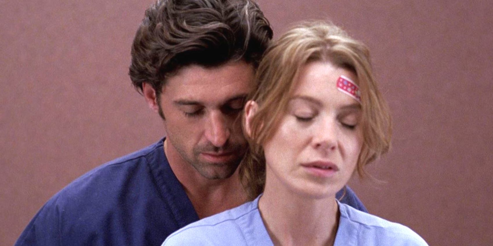 Derek embracing Meredith from behind