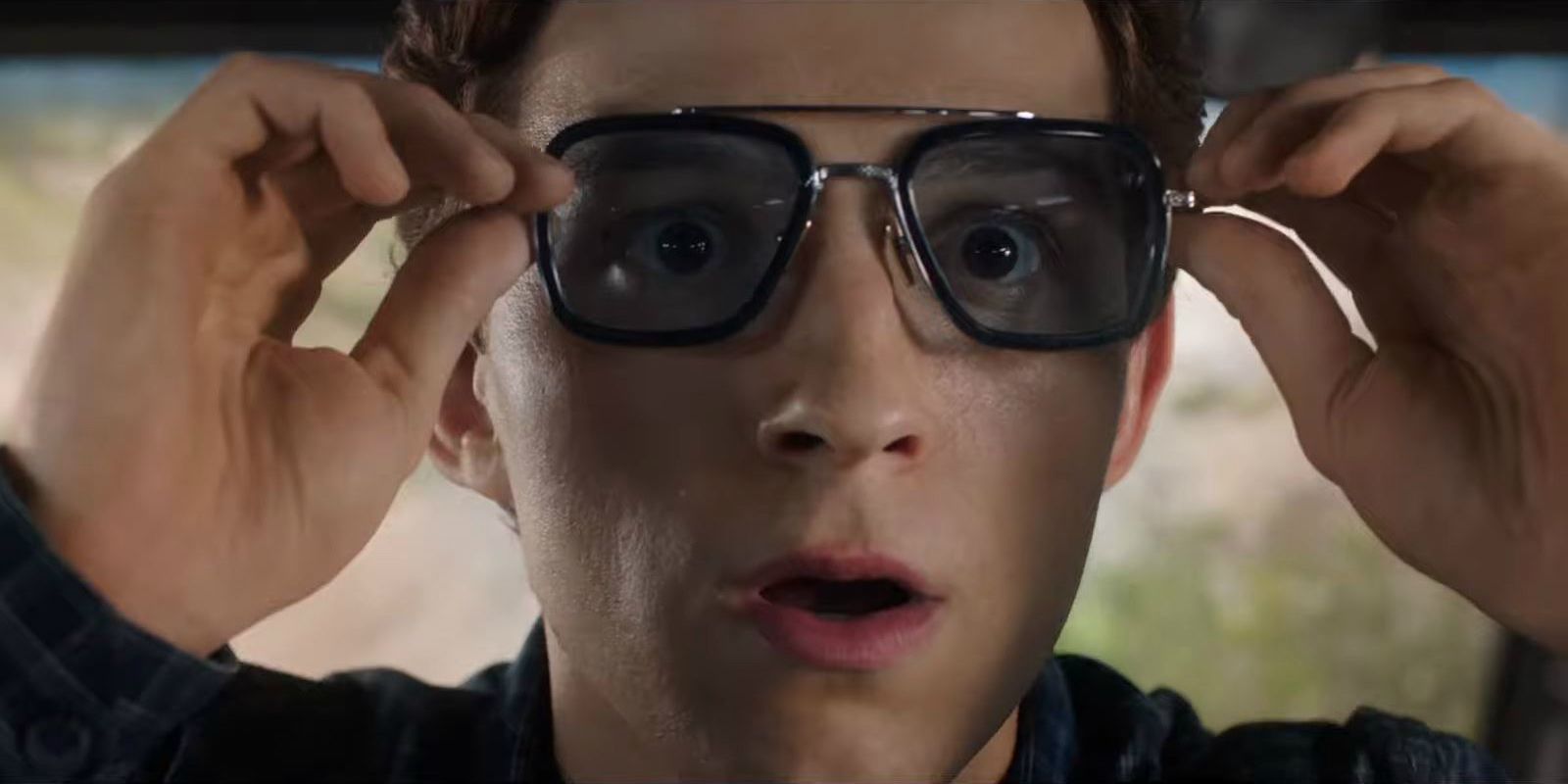 Peter Parker holds the glasses Tony Stark gave him in Spider-Man.