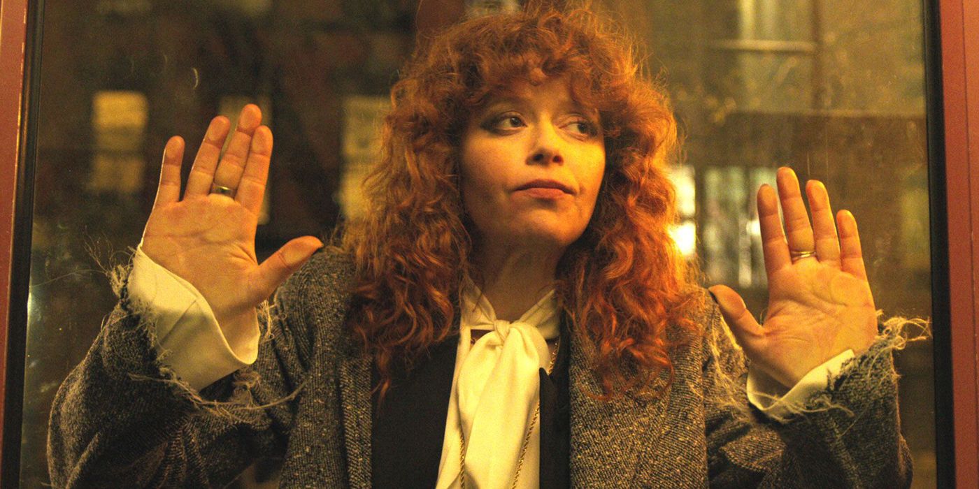 Nadia holding a glass door in Russian Doll.
