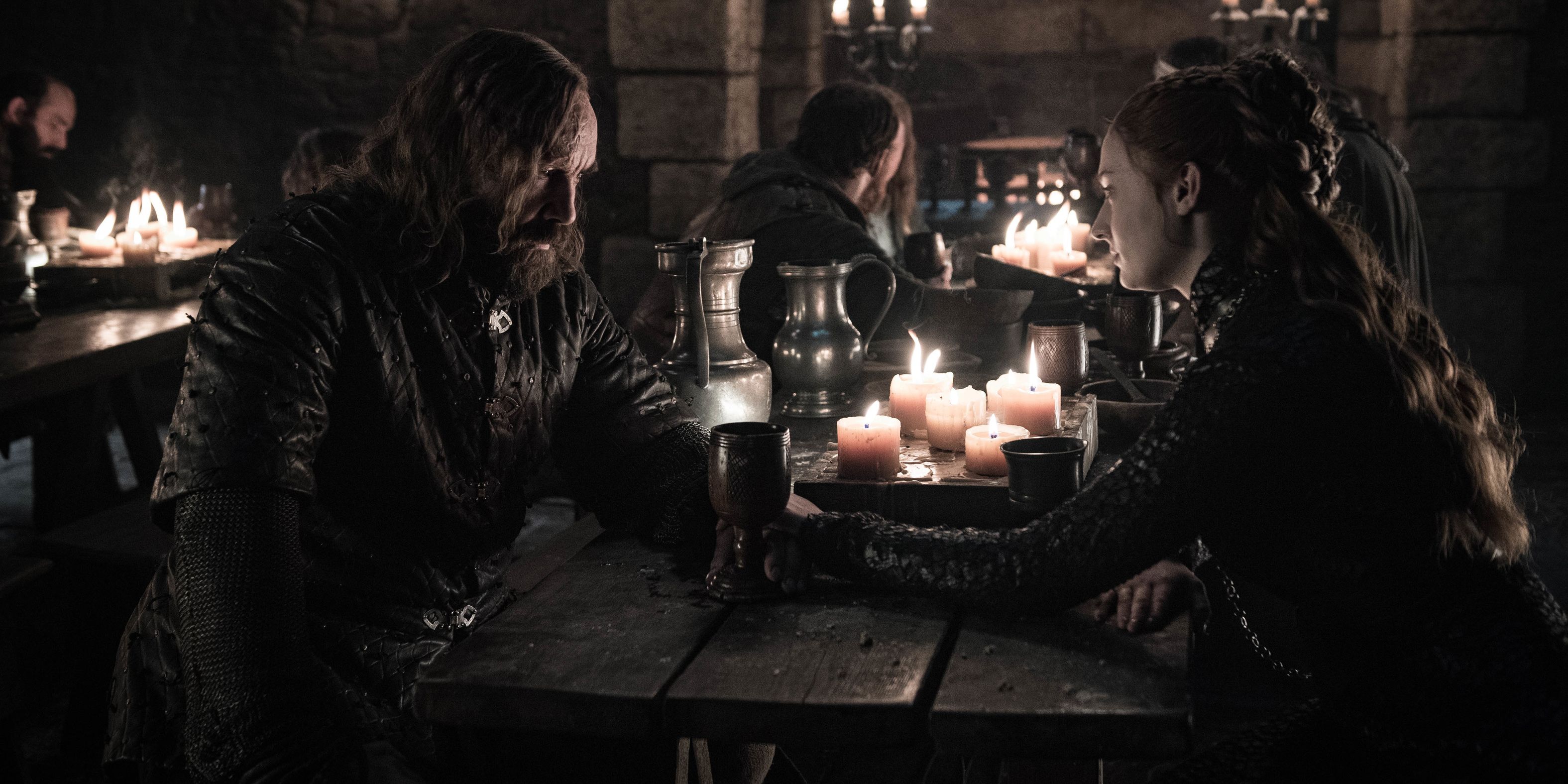 Sansa and The Hound sit at a table in Winterfell in Game of Thrones