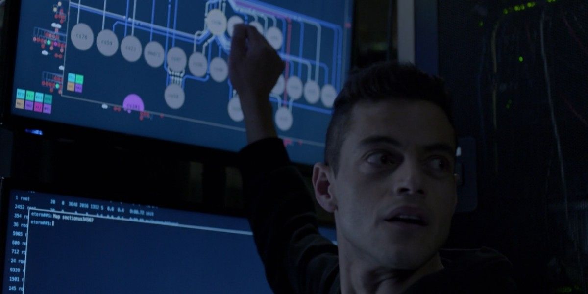 Elliot messing around with a touchscreen computer, looking behind him back in Mr. Robot.