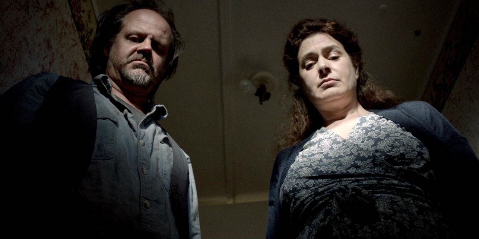 intimidation Jug Face, a man and a woman look down at the viewer with dissatisfaction