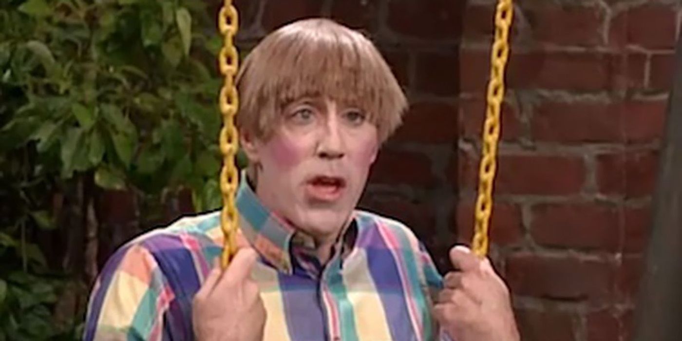 Stuart from MadTV, sitting on a swing wearing a multi-colored shirt.