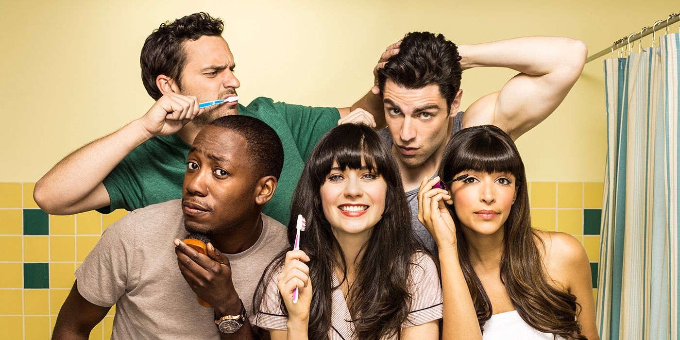The cast of New Girl posting for a cast photo in a bathroom