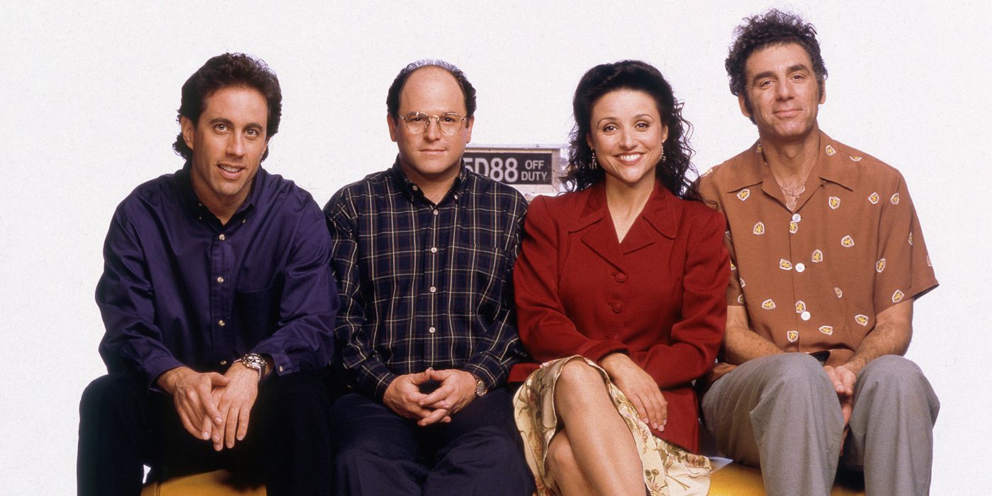 The Seinfeld cast smile at the camera while sitting on the hood of a taxi