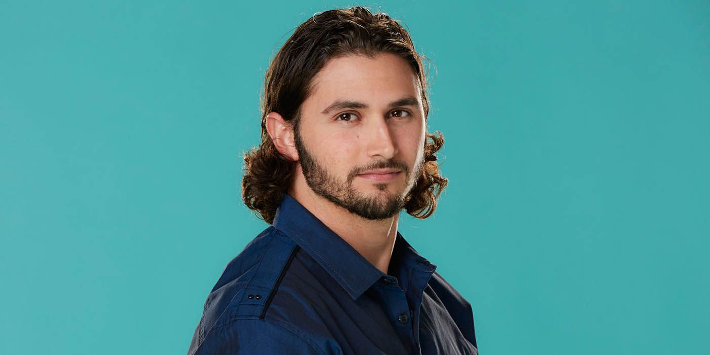 Victor Arroyo posing against a teal background for a Big Brother promo image