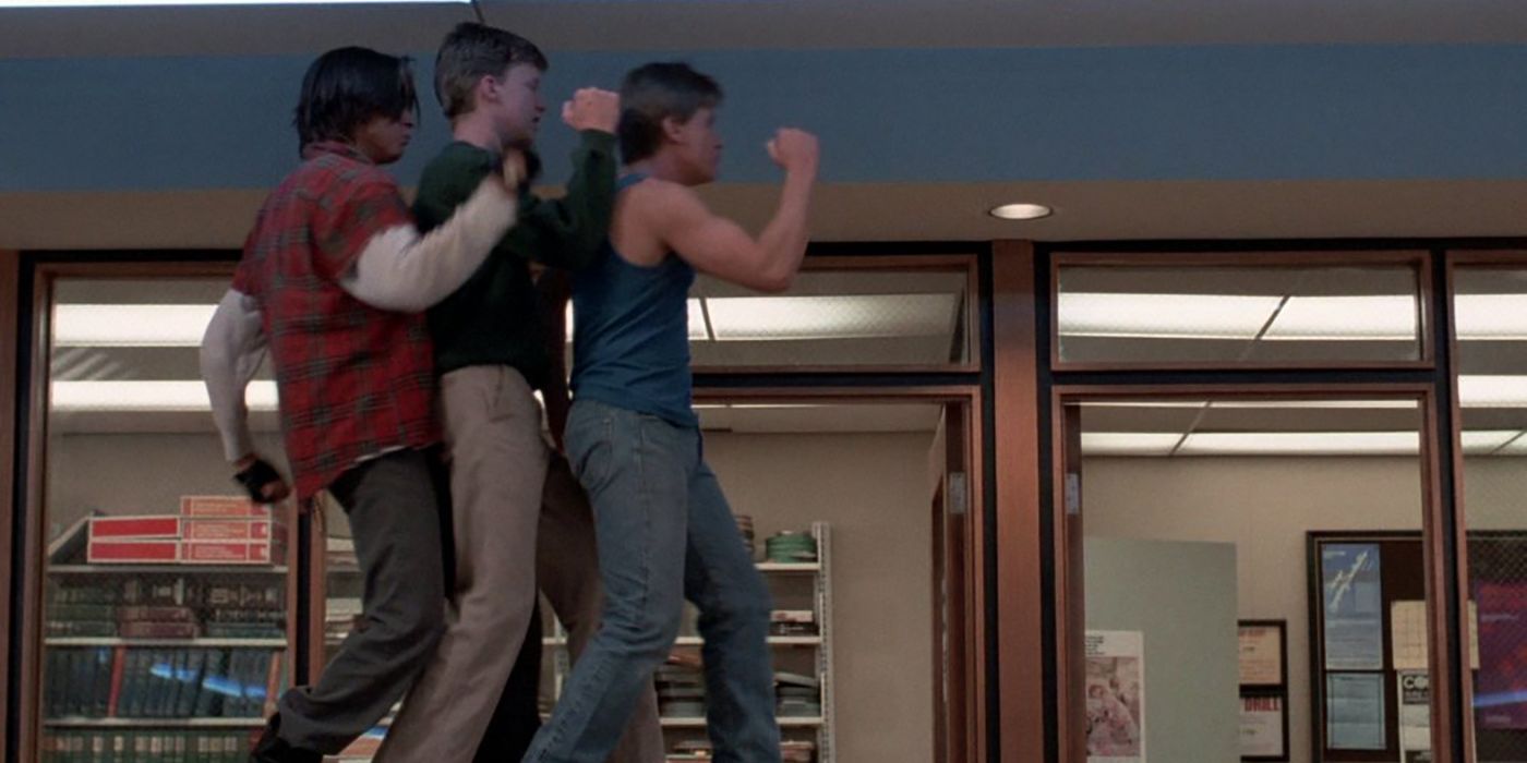 Three teenage boys dance in a library in The Breakfast Club.