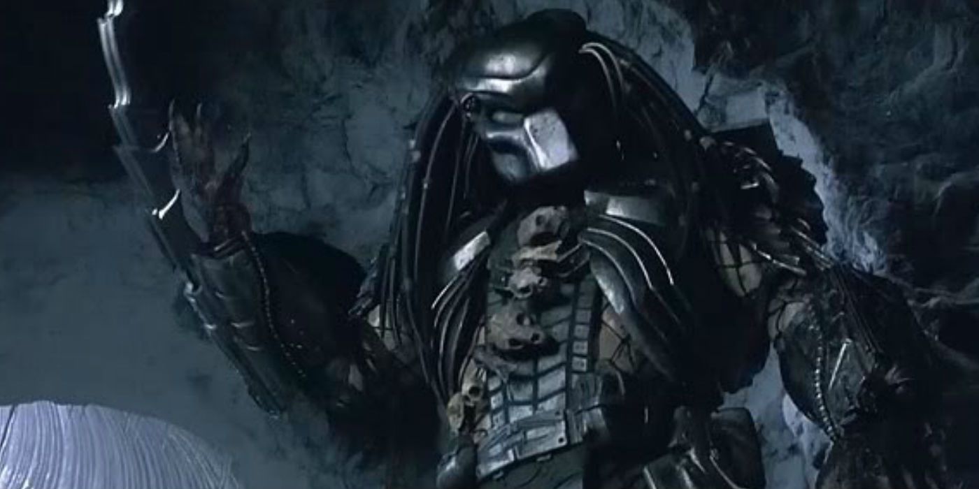 Predator raising his wrist blades in a cave in Alien vs. Predator