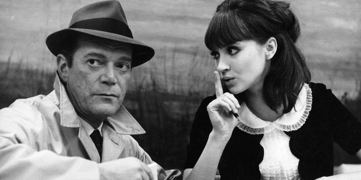 A woman sushing a man who's looking away in Alphaville.