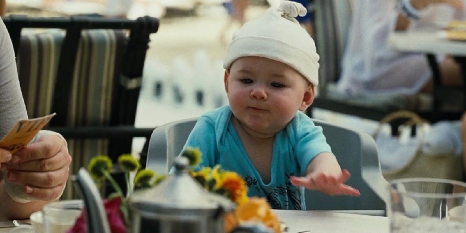Carlos the baby sitting at a table in The Hangover