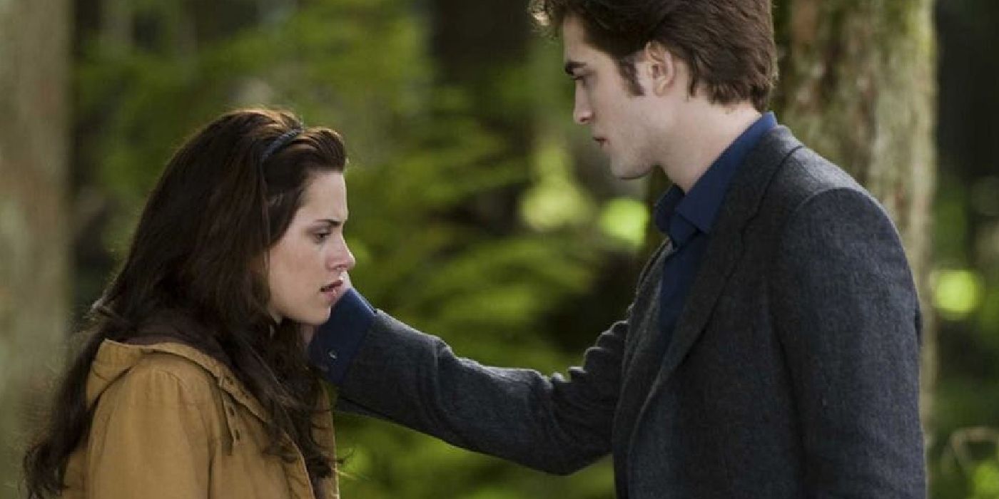 Bella and Edward standing in the woods in Twilight