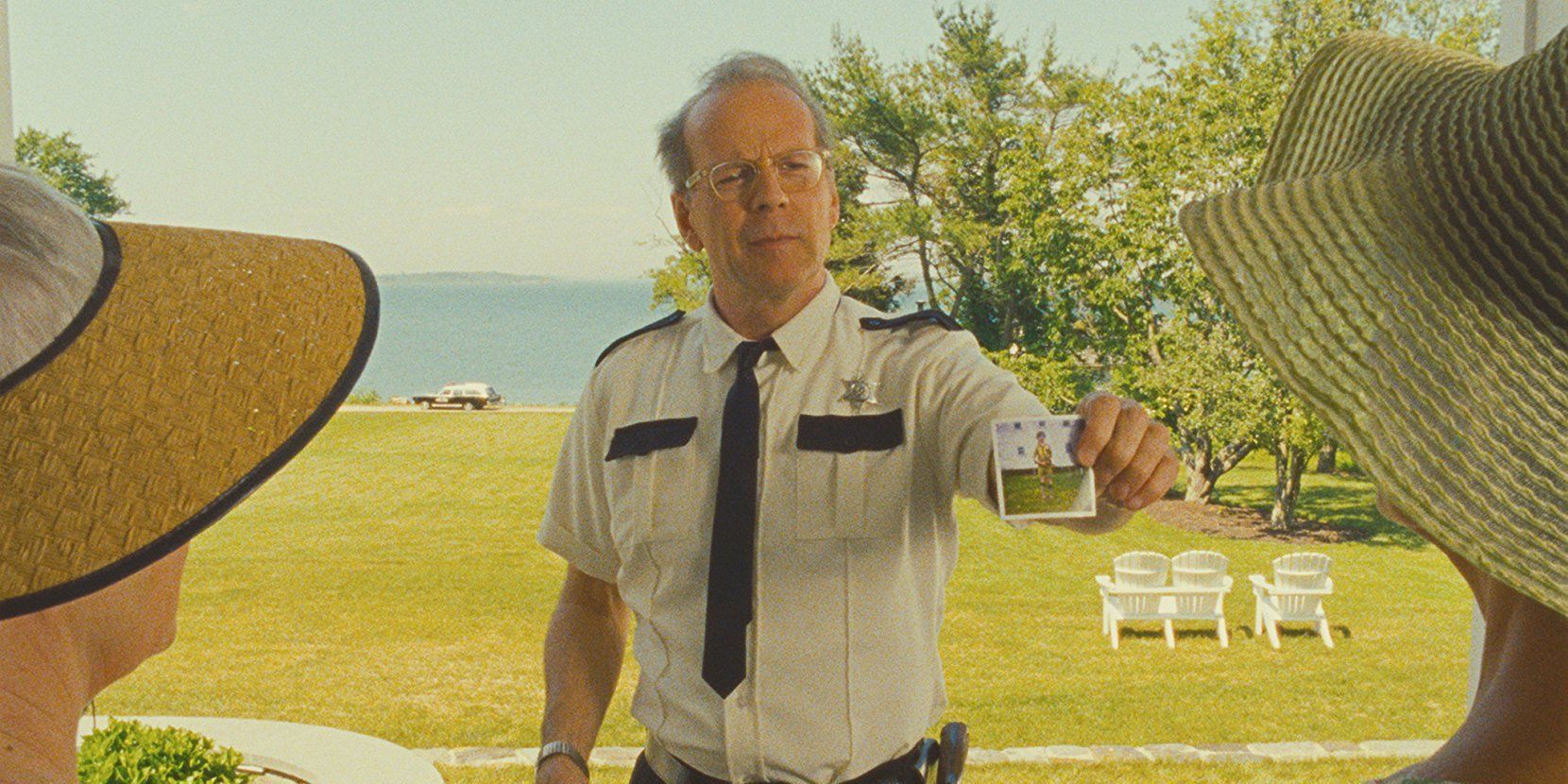 Captain Sharp holds up a photograph of a boy in Moonrise Kingdom