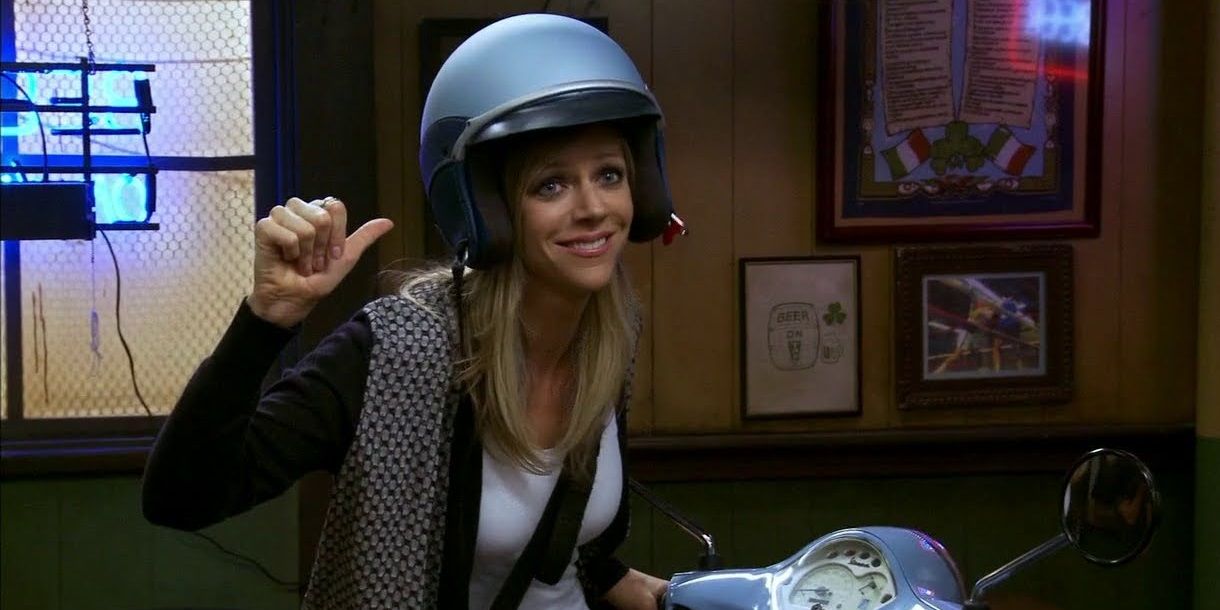 Dee points to herself as she wears a helmet and rides a bike in It's Always Sunny in Philadelphia.