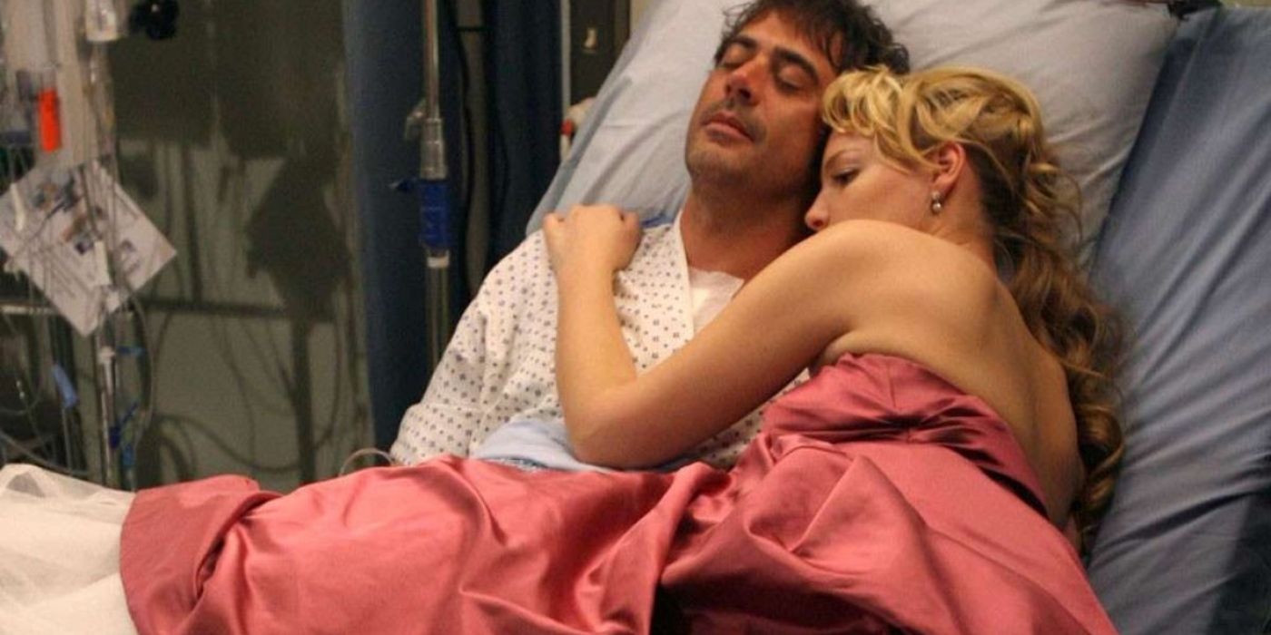 Izzie in formal dress cuddles up to Denny in hospital bed in Grey's Anatomy