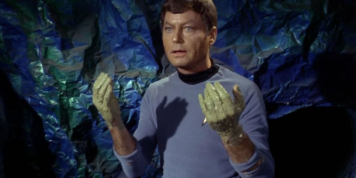 Dr. McCoy holds up his hands with green goo on them from Devil in the Dark
