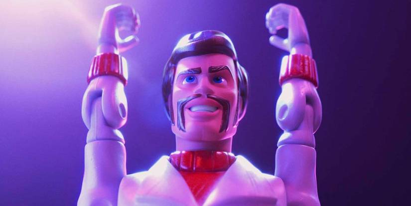 Duke Caboom poses with his arms up while smiling in Toy Story 4