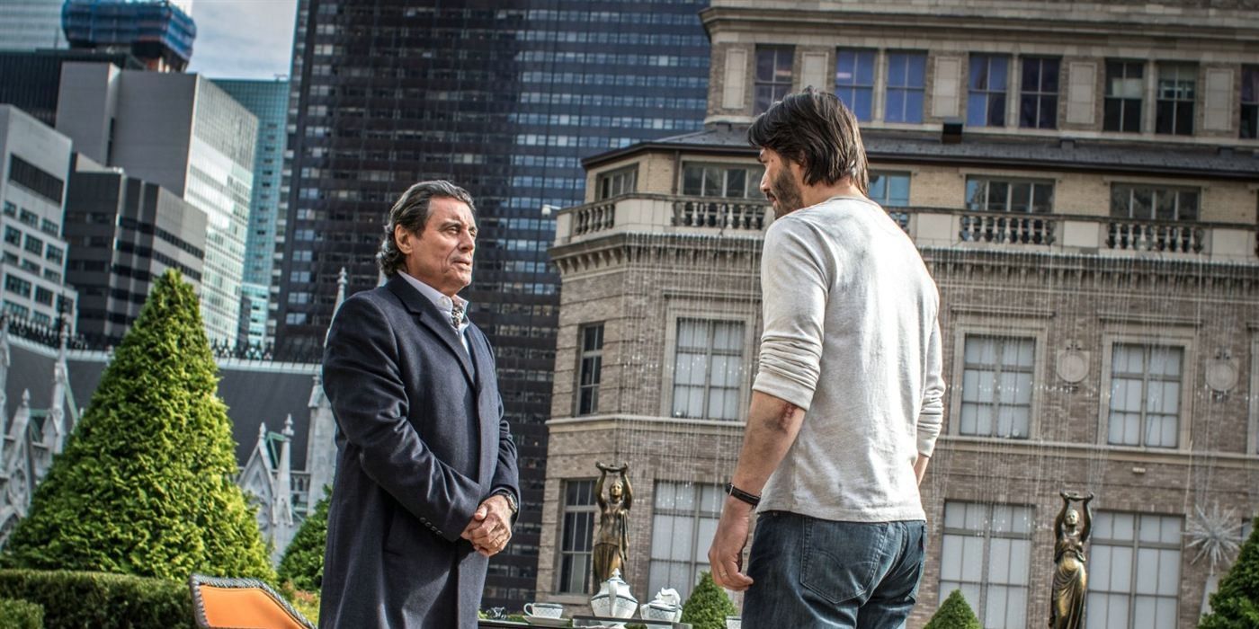 Ian McShane as Winston and Keanu Reeves as John Wick on the Continental terrace in John Wick: Chapter 3